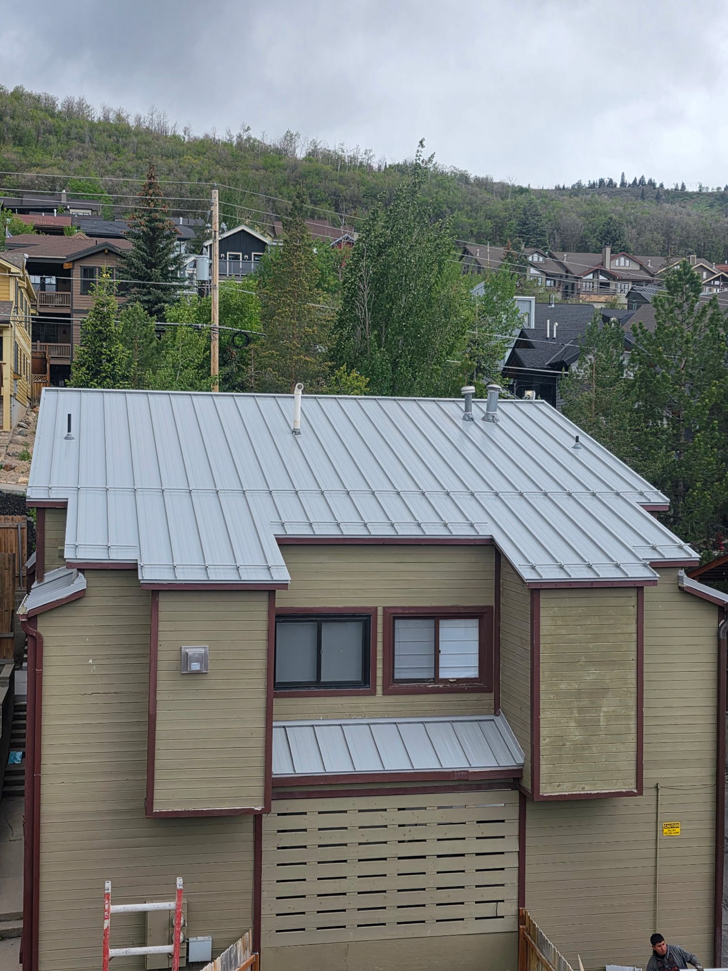 Silver standing seam metal roof installed on a Park City, Utah townhome